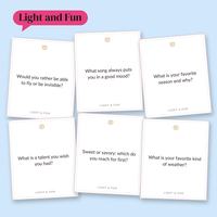 Six white Light and Fun cards scattered on light blue, including Would you rather be able to fly or be invisible? and What is a talent you wish you had? under a pink Light and Fun label